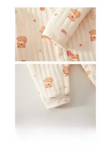 Détail des poignets matelassés doux et des motifs ours sur la barboteuse bébé