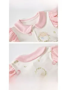 Detail view of cotton baby bodysuit with Peter Pan collar and cute bunny print