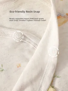 Close-up of baby bodysuit featuring food-grade POM resin snaps on soft cotton fabric
