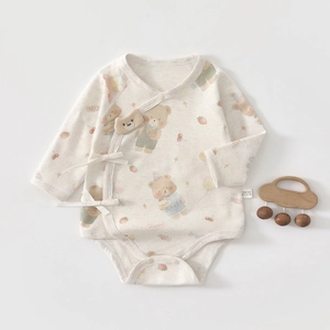 Detail of 100% cotton newborn bodysuit with cartoon bear print and soft lace-up design