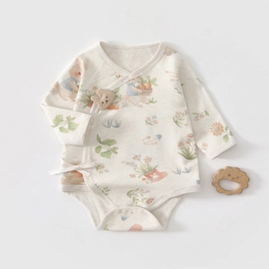 Detail of soft cotton baby bodysuit with rabbit print and side-tie kimono closure