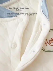 Détail du haut thermique matelassé pour bébé avec boutons-pression en résine POM sûrs