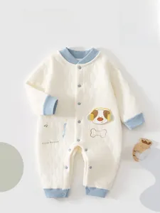 Close-up of quilted cotton baby romper featuring blue ribbed trim and cartoon embroidery