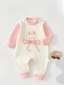 Detail of baby romper featuring a cute rabbit print and snap button closure for easy wear
