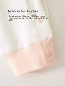 Detail of baby romper cuffs with POM food-grade resin snaps and soft knit texture