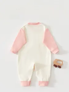 Detailed back view of a soft cotton baby bodysuit with pink cuffs and beige fabric