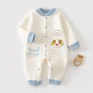 Detailed view of quilted cotton baby romper with cute dog patterns and snap buttons