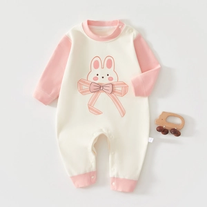 Detail of baby romper with pink bow, cute rabbit print, and convenient snap buttons