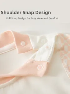Detail of shoulder snap buttons on organic cotton baby bodysuit for easy dressing
