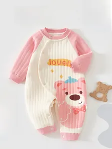 Detail view of quilted baby romper featuring a cute pink bear print and lovely text