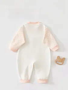 Detail view of the back of a baby long sleeve bodysuit with pink ribbed accents