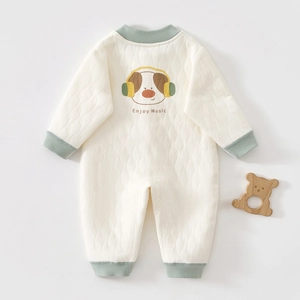 Close-up of diamond quilted cotton fabric with cartoon dog print and ribbed cuffs