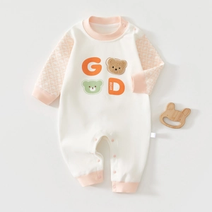Close-up of soft cotton baby romper with 3D plush bear patch and snap button closure