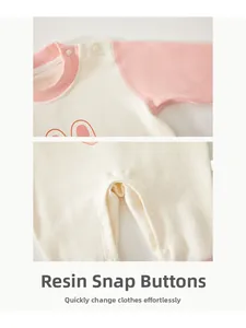 Detail view of high quality resin snap buttons on cotton baby jumpsuit for easy changing