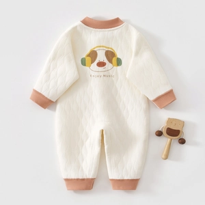 Close-up of quilted cotton baby onesie featuring a cute dog print and ribbed cuffs