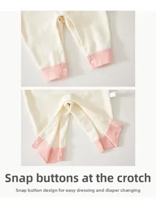 Detail of metal snap fasteners on newborn romper for easy diaper changes