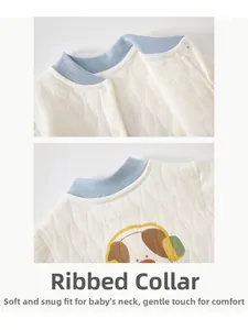 Detail of baby quilted cotton bodysuit with hemmed neckline and cartoon dog print