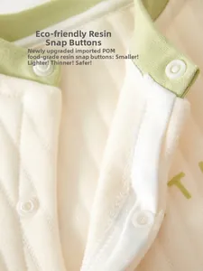 Close-up of quilted baby romper neckline with eco-friendly resin snap buttons and soft trim