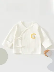 Detail of newborn cotton wrap top with cute bunny moon embroidery and soft fabric texture