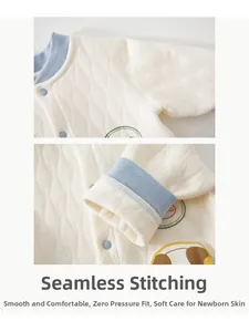 Detail of baby quilted romper showing boneless sewing seams and soft cotton fabric texture