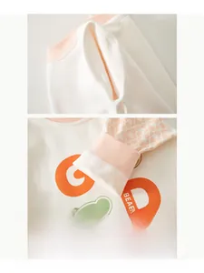 Detailed close-up of ribbed neckline and cuffs on soft organic cotton baby romper