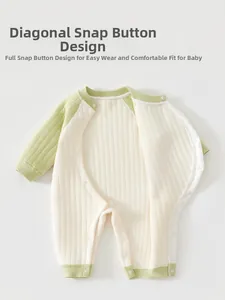 Detail view of diagonal snap closures and quilted warm fabric on infant romper