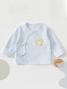 Close-up of soft cotton baby wrap top with rabbit embroidery and side tie closure
