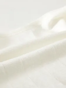Close-up of soft ribbed cotton fabric showing breathable texture for newborn baby clothes