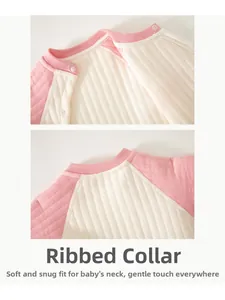 Close-up of baby quilted bodysuit with a bound neckline and pink snap button closure