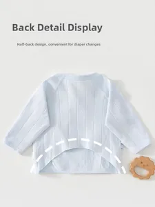 Detail of light blue newborn kimono top with star patterns and breathable cotton texture