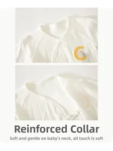 Detail of baby cotton top with bear embroidery and soft bound neckline texture