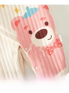 Close-up of baby romper with pink bear print and snap button closure detail