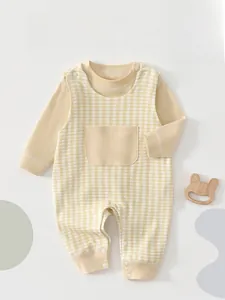 Detail of infant long-sleeve set with plaid overalls and snaps for easy diapering
