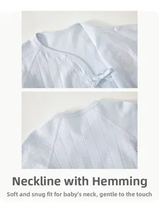 Detail of soft cotton baby wrap top featuring a hemmed neckline and breathable pointelle fabric