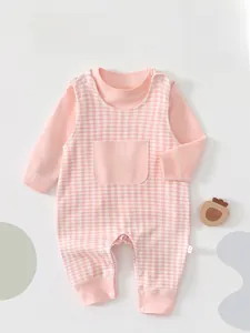 Close-up of baby pink plaid jumpsuit with soft cotton fabric and snap button details