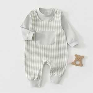 Flat lay of soft cotton baby set with green checkered overalls and gray inner shirt