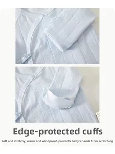 Detail of baby cotton top featuring foldable anti-scratch mittens on soft blue sleeves