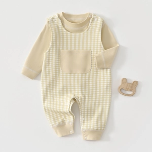 Detail of baby cotton two-piece set with yellow plaid overalls and snap buttons