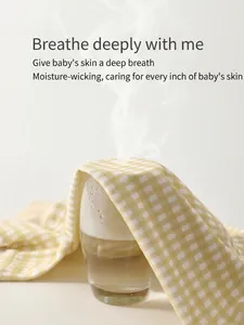 Breathable cotton baby romper set showing steam passing through yellow checkered fabric