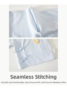Detail of newborn baby light blue cotton shirt with flat seams and side tie closure