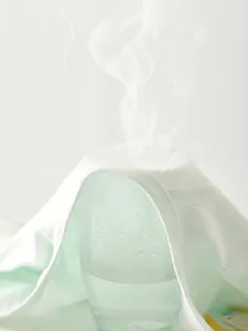 Breathable light green cotton baby kimono top showing steam ventilation test detail