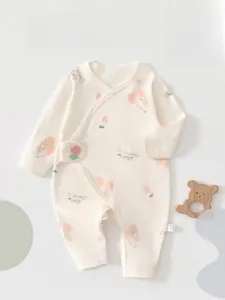 Detailed macro view of pure cotton newborn romper with bear and cherry prints