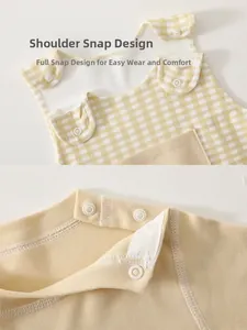 Detail showing the snap buttons on the shoulder of the cotton baby bodysuit