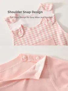 Detail view of cotton knitted baby romper with easy shoulder snap buttons and pink patterns