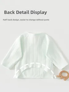 Detail of baby half-back shirt with open hem design for easy diaper changes in light green