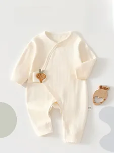 Detail of newborn long-sleeved bodysuit in beige ribbed cotton with strawberry embroidery