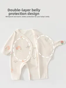 Detail of baby cotton romper featuring a double-layer belly protection and bear print