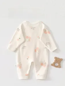 Detailed flat lay of long sleeve cotton baby romper with cherry and bear print details