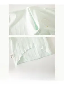 Detailed macro view of seamless bone-free stitching and soft cotton rib fabric on baby shirt