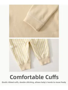 Detail of elastic ribbed cuffs and double stitching on baby romper for flexible movement